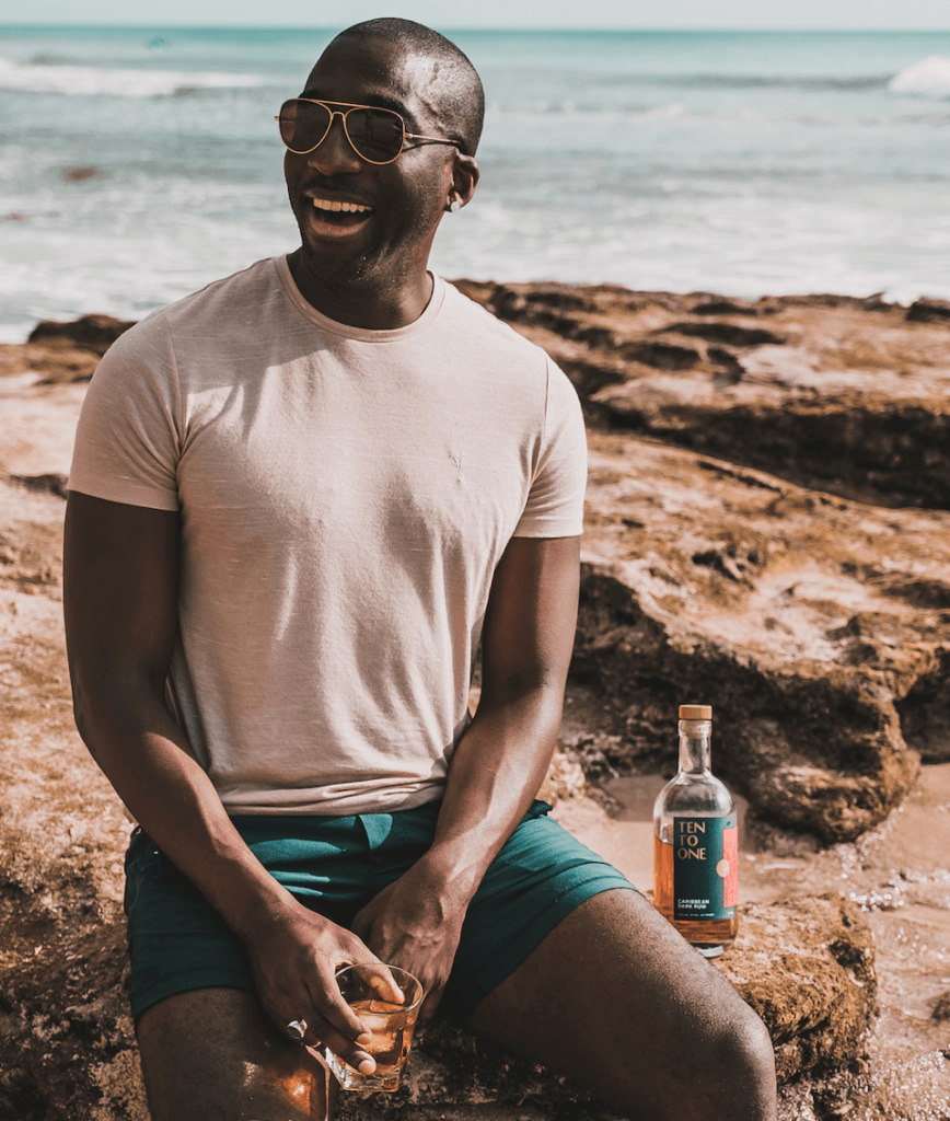 Marc Farrell on beach with rum