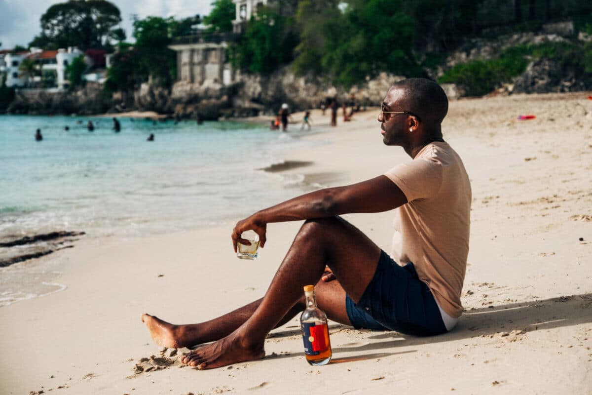 Marc Farrell on beach with rum