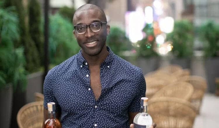 Marc Farrell holding bottles of rum