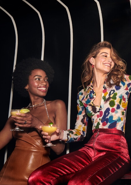 Women enjoying Ten To One cocktails