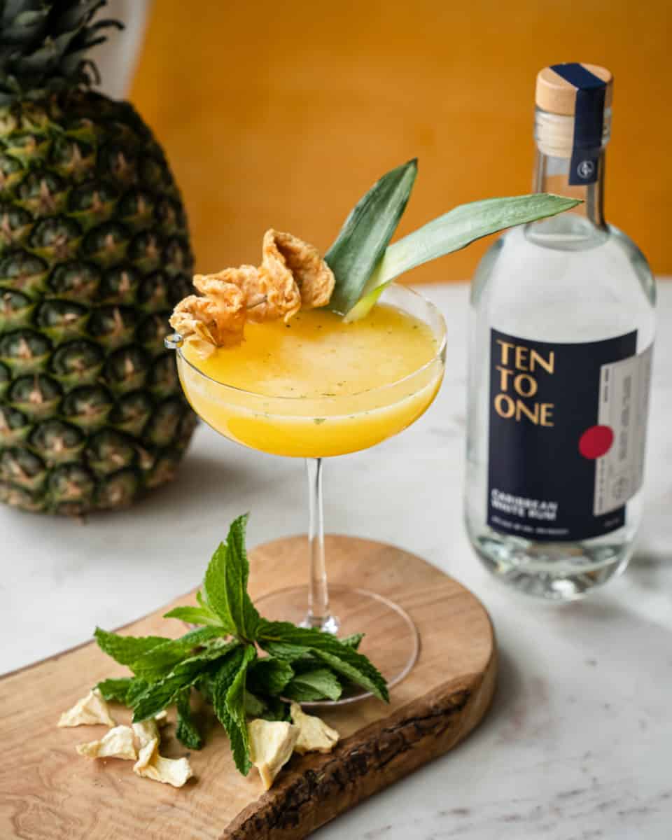 Pineapple Mint Daiquiri with Ten To One white Rum bottle and coupe